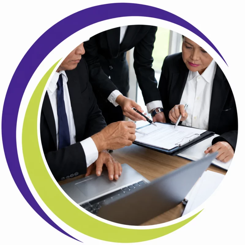 Business professionals reviewing workplace policies and compliance documents during a team meeting.