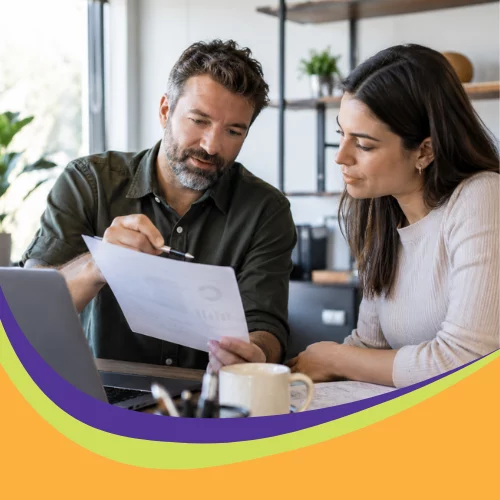 Business owner and employee reviewing a workplace AI use policy together